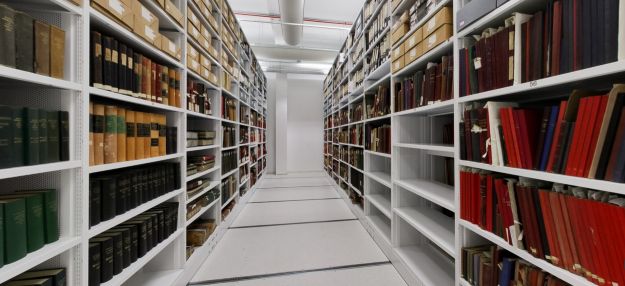 Archive storage aisle with shelves of books and archival collections