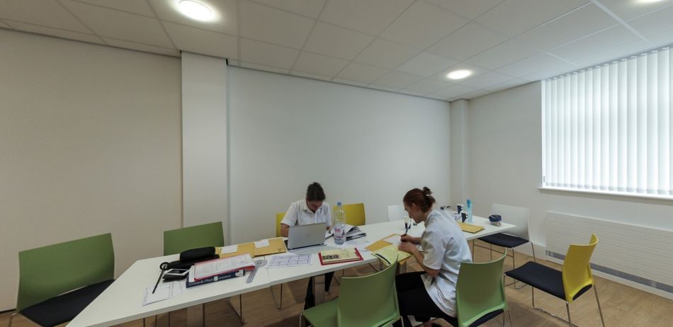 Student breakout room with tables, chairs and collaborative study space