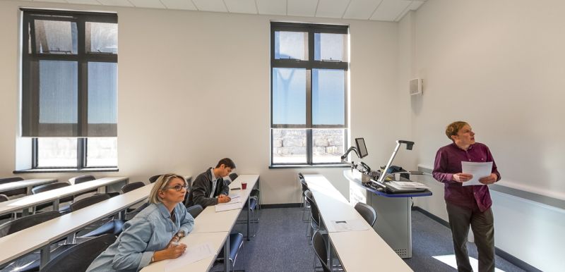 Teaching room with lecturer and students in a bright modern classroom